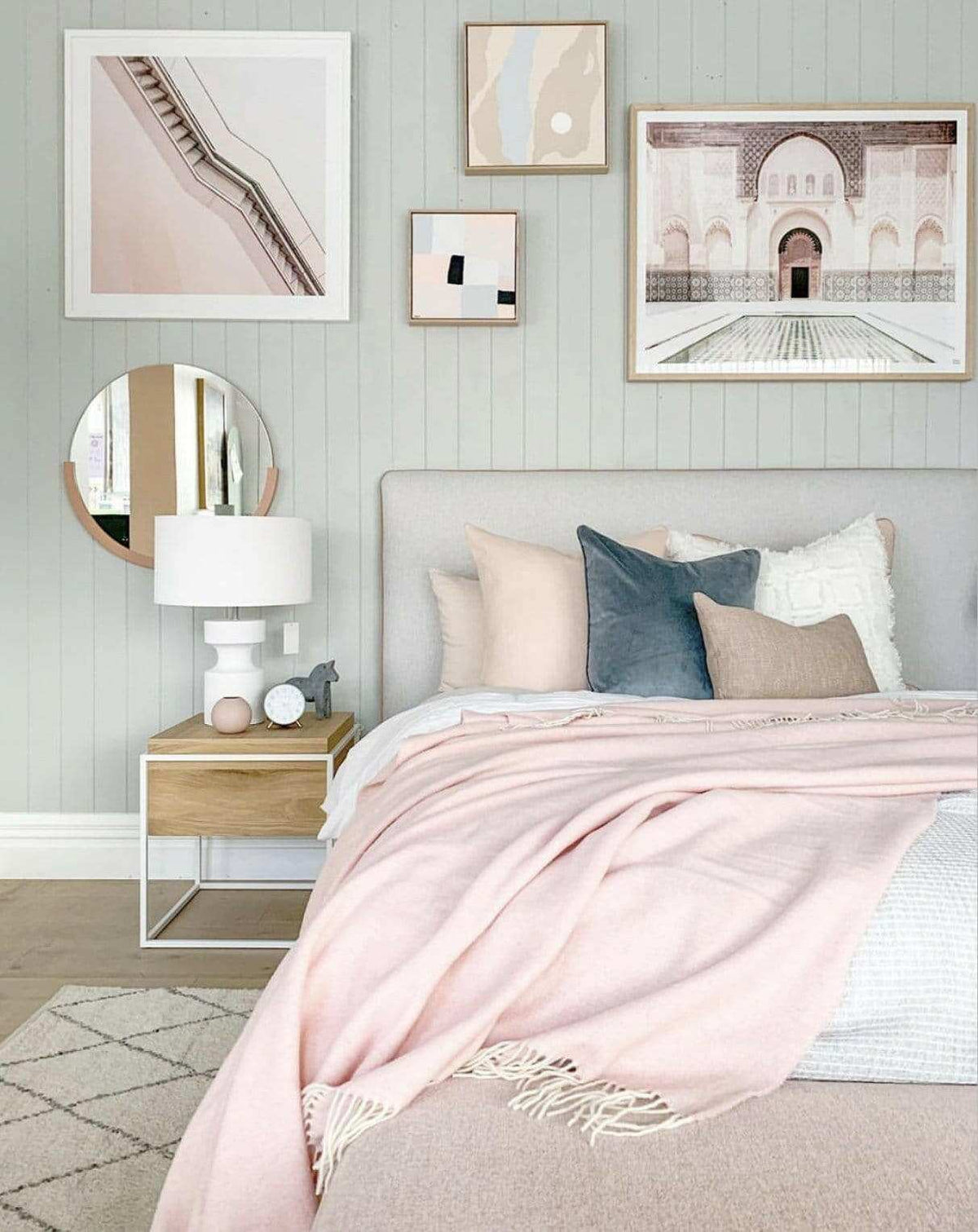 Middle of Nowhere Dawn round desert mirror in a modern bedroom interior with pastel tones and framed artwork on the wall