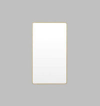Flynn Curve series brass framed rectangular leaning mirror with rounded corners and antique gold leaf finish