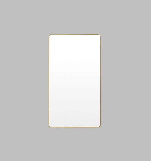 Flynn Curve series brass framed rectangular leaning mirror with rounded corners and antique gold leaf finish