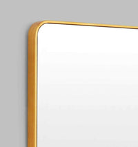 Flynn Curve series brass mirror with rounded corners and antique gold leaf finish, suitable for entry or hallway.