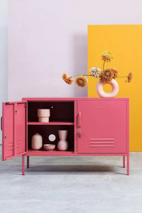 Pink Mustard Made Locker 'The Lowdown Berry' with open door displaying ceramic decor and flowers on top against yellow and purple background