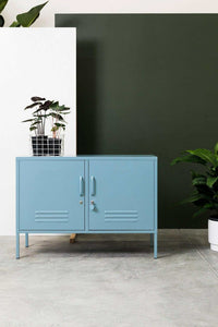 Mustard Made Locker The Lowdown Ocean blue metal storage cabinet with handles and locks against green and white wall