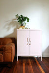 Pink Mustard Made Locker Midi Blush with double doors and minimalist design in living room next to brown leather sofa