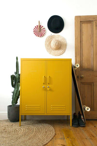 Yellow Mustard Made Locker with double doors and ventilation vents in stylish home setting