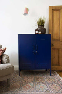 Navy Mustard Made Locker Midi with handles, locks, and air vents in living room setting.