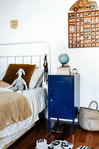 Mustard Made Locker The Shorty Navy metal bedside storage cabinet with handle and lock next to white bed