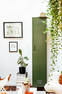 Green Mustard Made Locker against white wall with framed plant art and indoor plants around