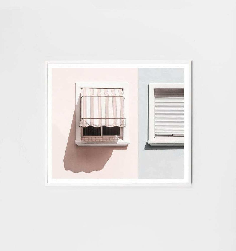 Minimalist Middle Of Nowhere Neighbours framed print featuring two adjacent windows in pastel pink and gray tones with white frame.