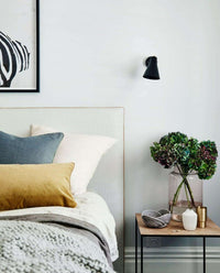 Caramel velvet norsu Studio Cushion with blush leather piping on a bed in a modern bedroom setting