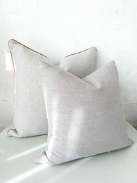 Two norsu cushion collection pillows in Lexus Haze fabric with charcoal leather piping, handmade in Melbourne.