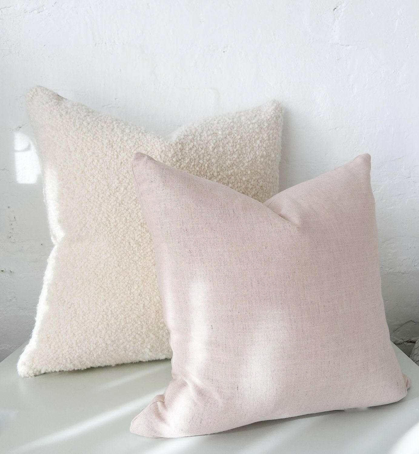 norsu cushion Lexus Rosewater in soft pink made with high-quality Warwick fabric, shown with a textured cream cushion, handmade in Melbourne