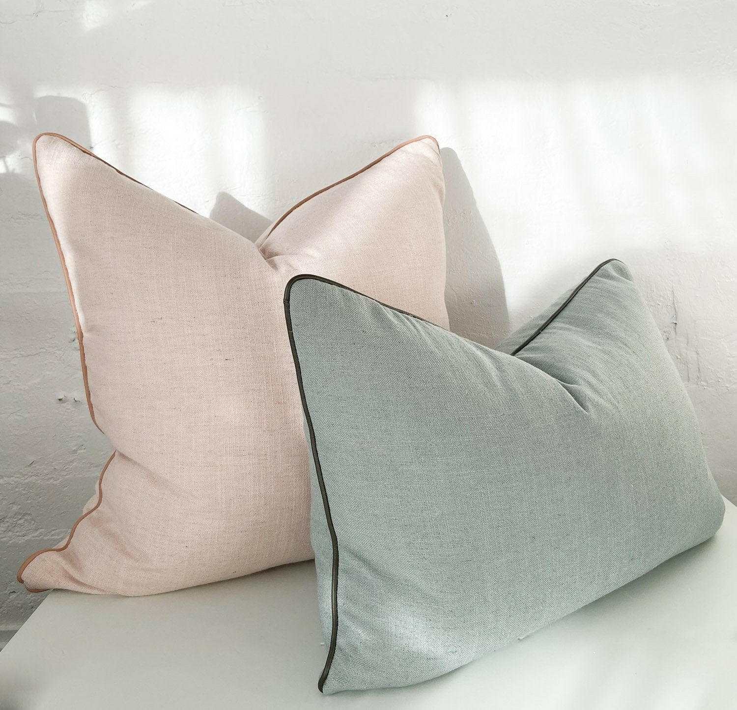 norsu Studio Cushion set featuring Lexus Rosewater fabric with blush leather piping, handmade with high-quality Warwick fabrics and feather down filling, displayed in soft natural light