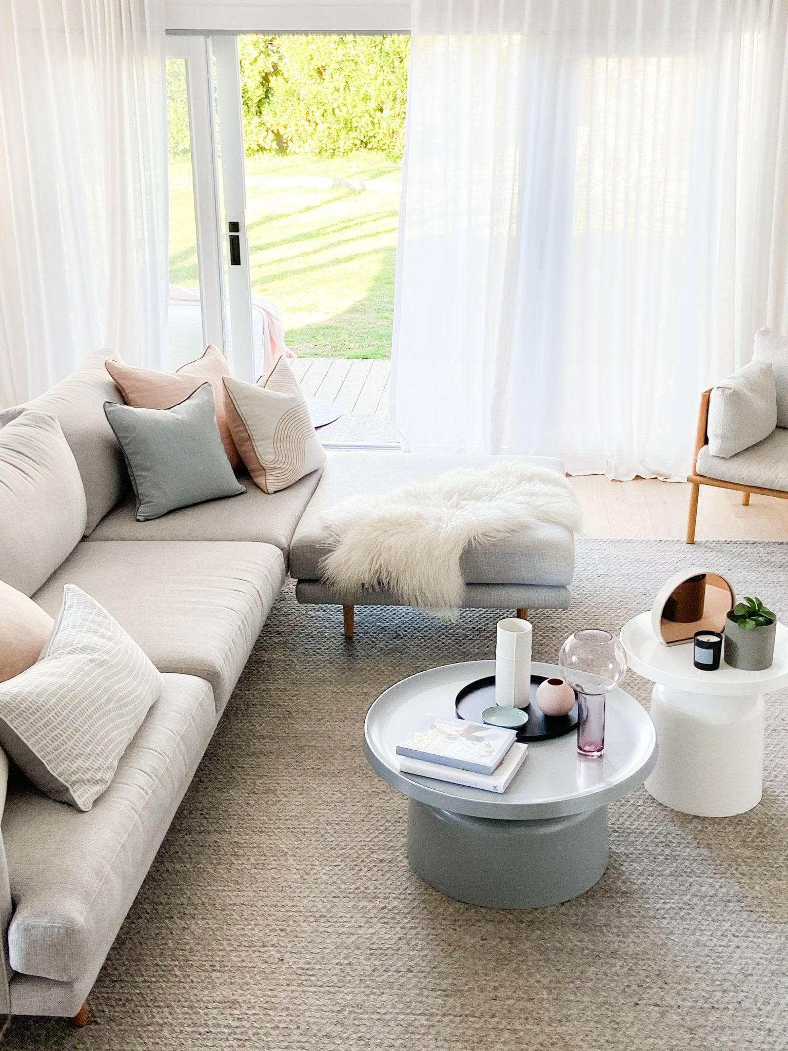 norsu Studio Cushion Lexus Rosewater with Blush Leather Piping on beige sofa in bright living room