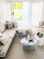 norsu Studio Cushion Lexus Rosewater with Blush Leather Piping on beige sofa in bright living room