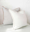 norsu Studio Cushion set featuring Lindeman Snow with blush piping, handmade with Warwick fabrics and feather down filling, perfect for home decor.