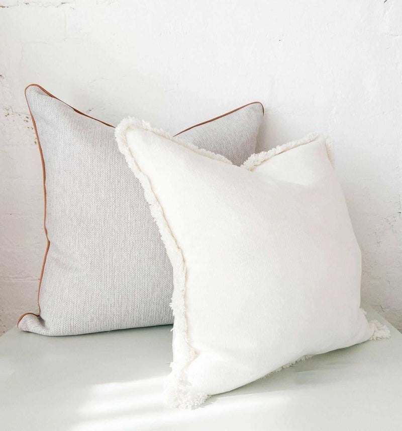 norsu Studio Cushion set featuring Lindeman Snow with blush piping, handmade with Warwick fabrics and feather down filling, perfect for home decor.