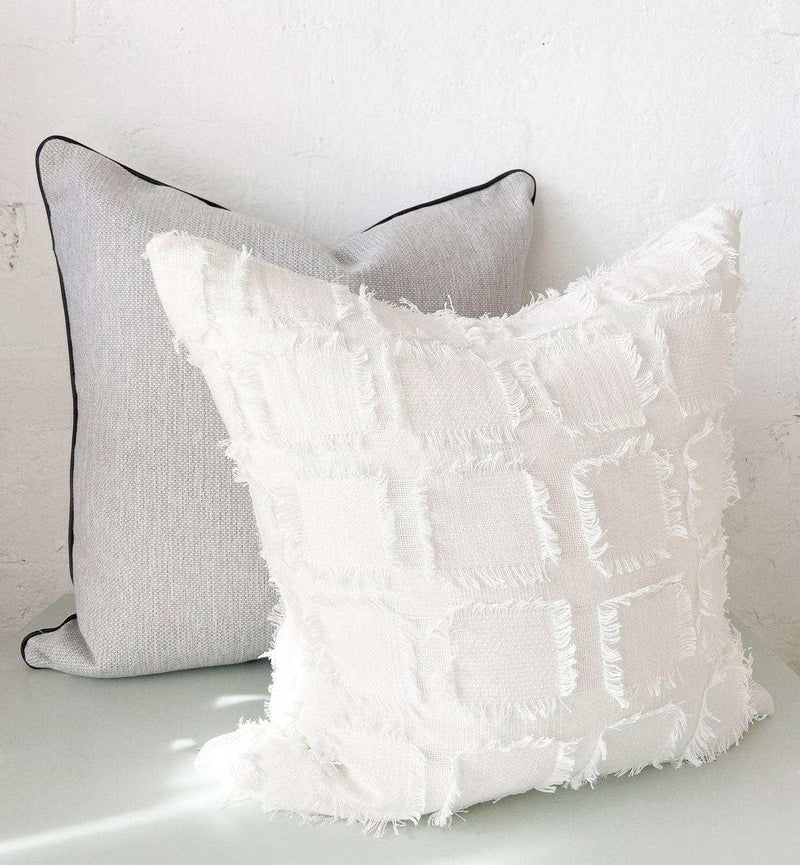 norsu cushion set with Lindeman Snow textured pillow and charcoal piped gray pillow designed with Warwick fabrics and feather down fillings