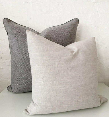 Two norsu cushions in Lindeman Steel fabric, one light beige and one dark gray, displayed against a white background