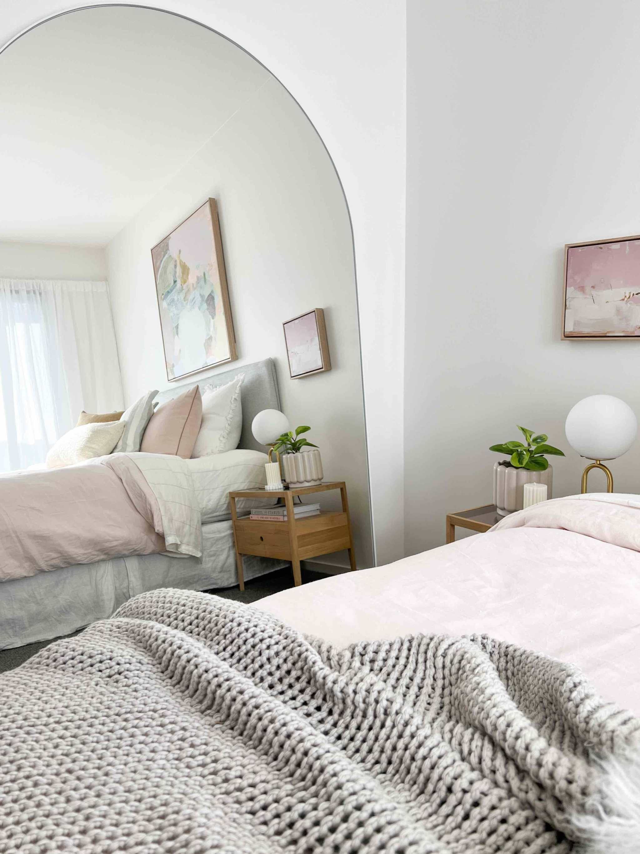 Oversized Middle of Nowhere Bjorn Arch mirror in a modern bedroom setting with neutral decor