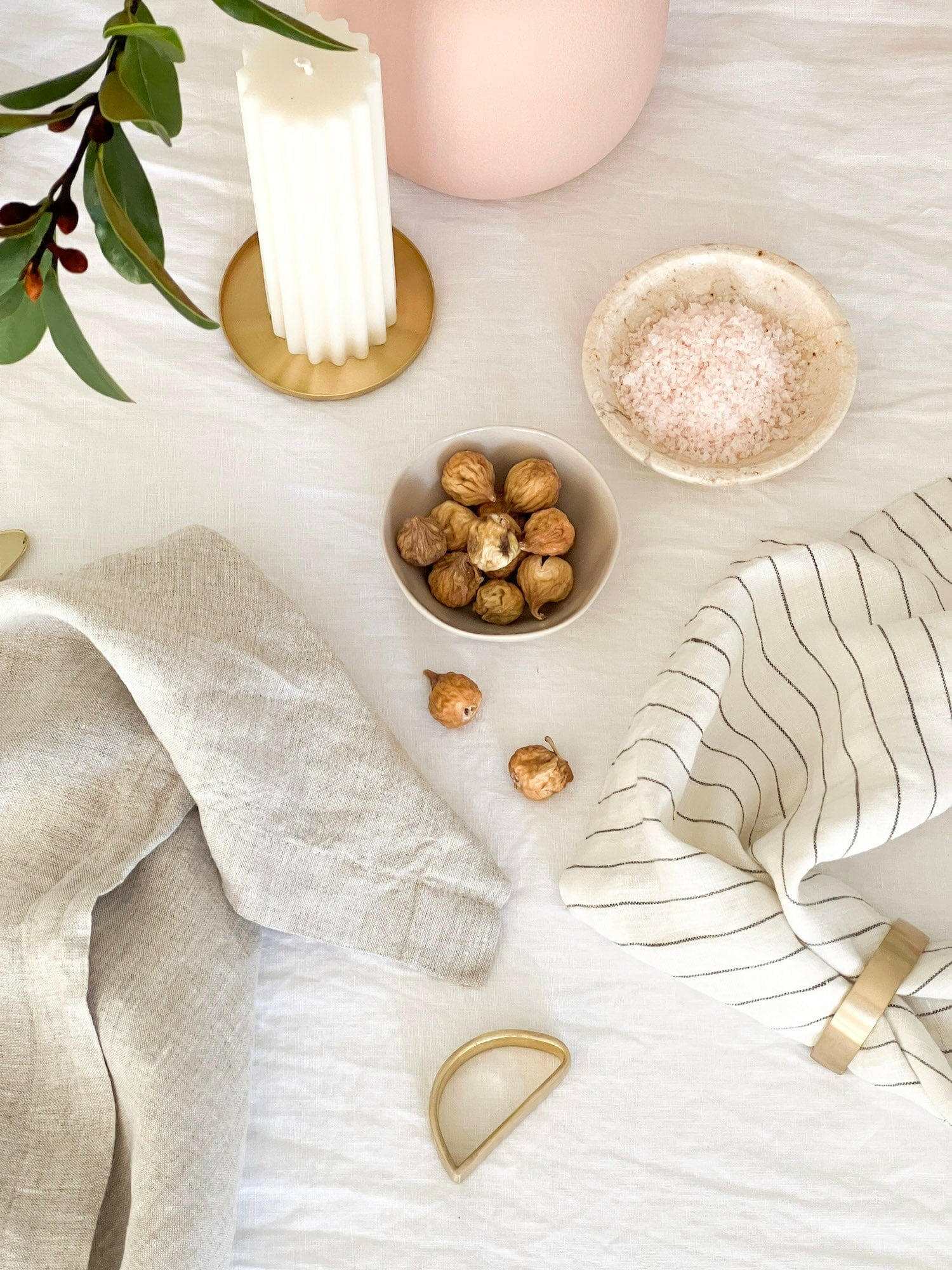 Set of four Rendr 100 Linen Napkins in natural color displayed with rustic table decor