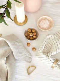 Set of four Rendr 100 Linen Napkins in natural color displayed with rustic table decor