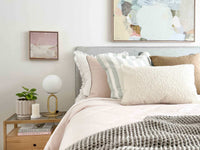 Brass desk lamp with frosted glass shade on bedside table in modern bedroom setting