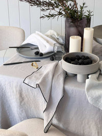 Rendr Amara Stitch cool grey 100% linen tablecloth with contrasting embroidered edging on a minimalist table setting