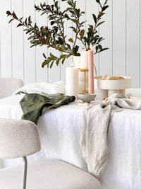 Set of four Rendr 100% linen natural napkins on a white dining table with decor