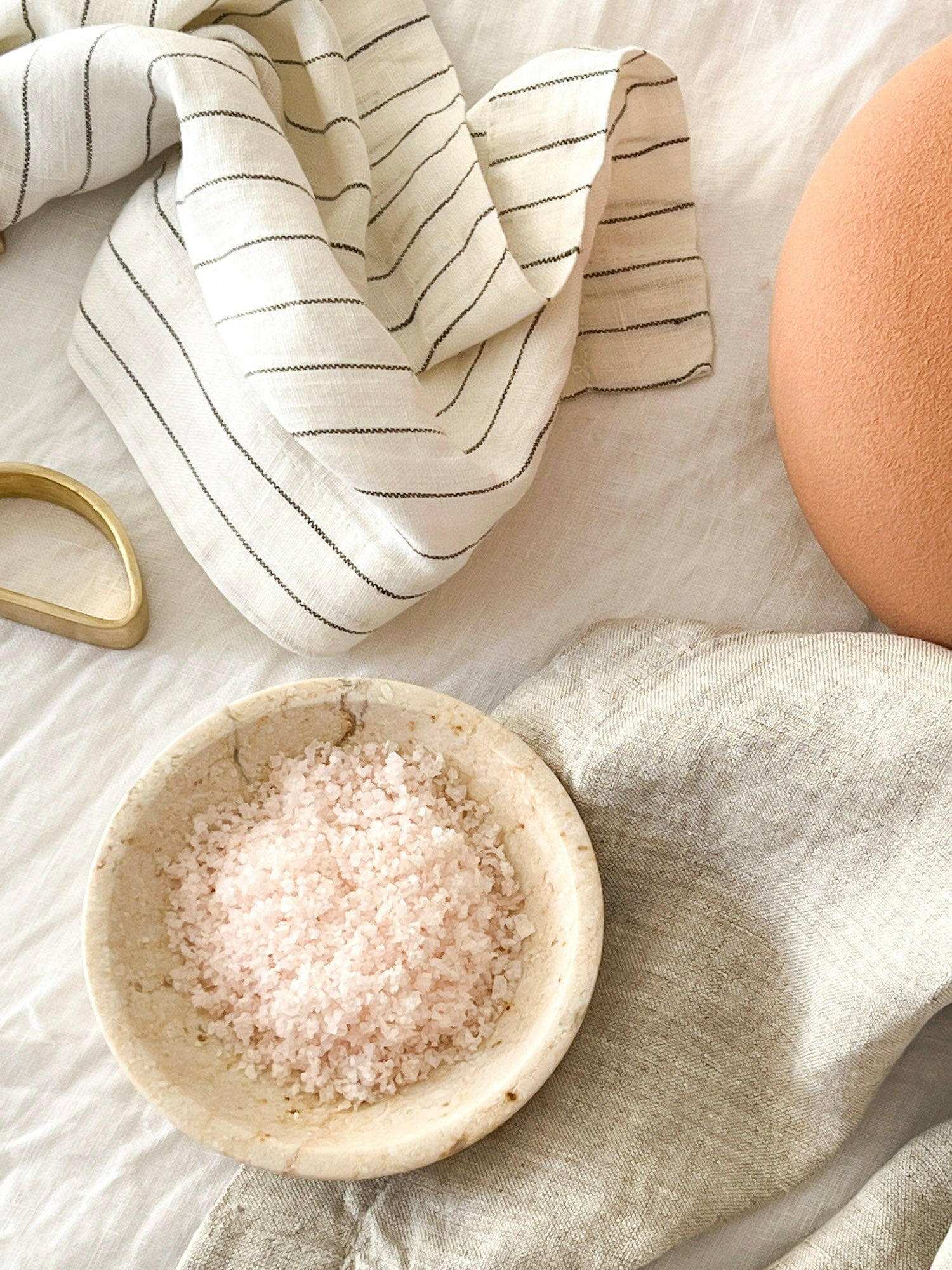 Rendr 100% linen napkins natural striped set of four on beige fabric with pink salt in ceramic bowl and terracotta pot