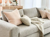 norsuHOME sofa beige fabric with soft cushions and a cozy throw in a stylish living room setting