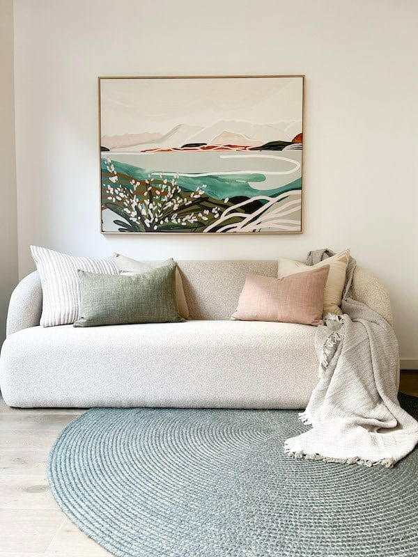 Blush norsu Studio Washable Cushion on sofa with cozy throw in modern living room