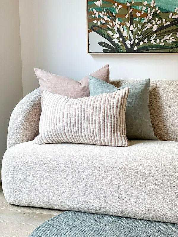 norsu Studio washable cushions in duck egg and neutral tones on a modern beige sofa