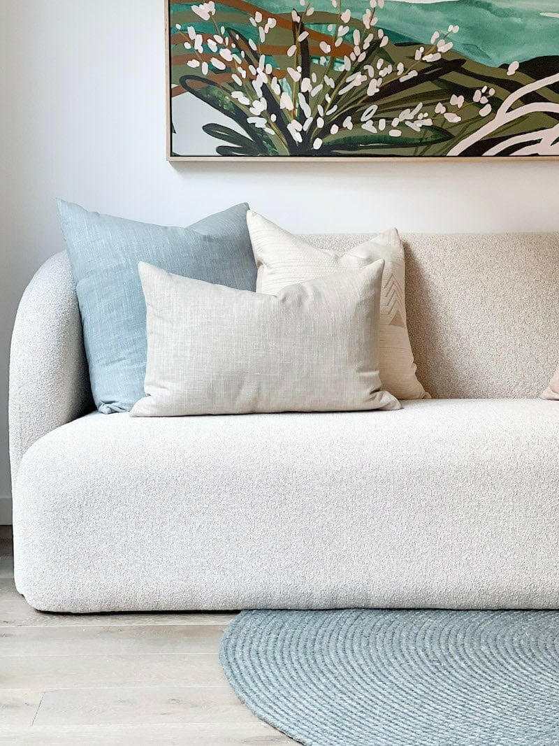 norsu Studio Washable Cushion Duck Egg color on white sofa with neutral cushions and floral artwork above