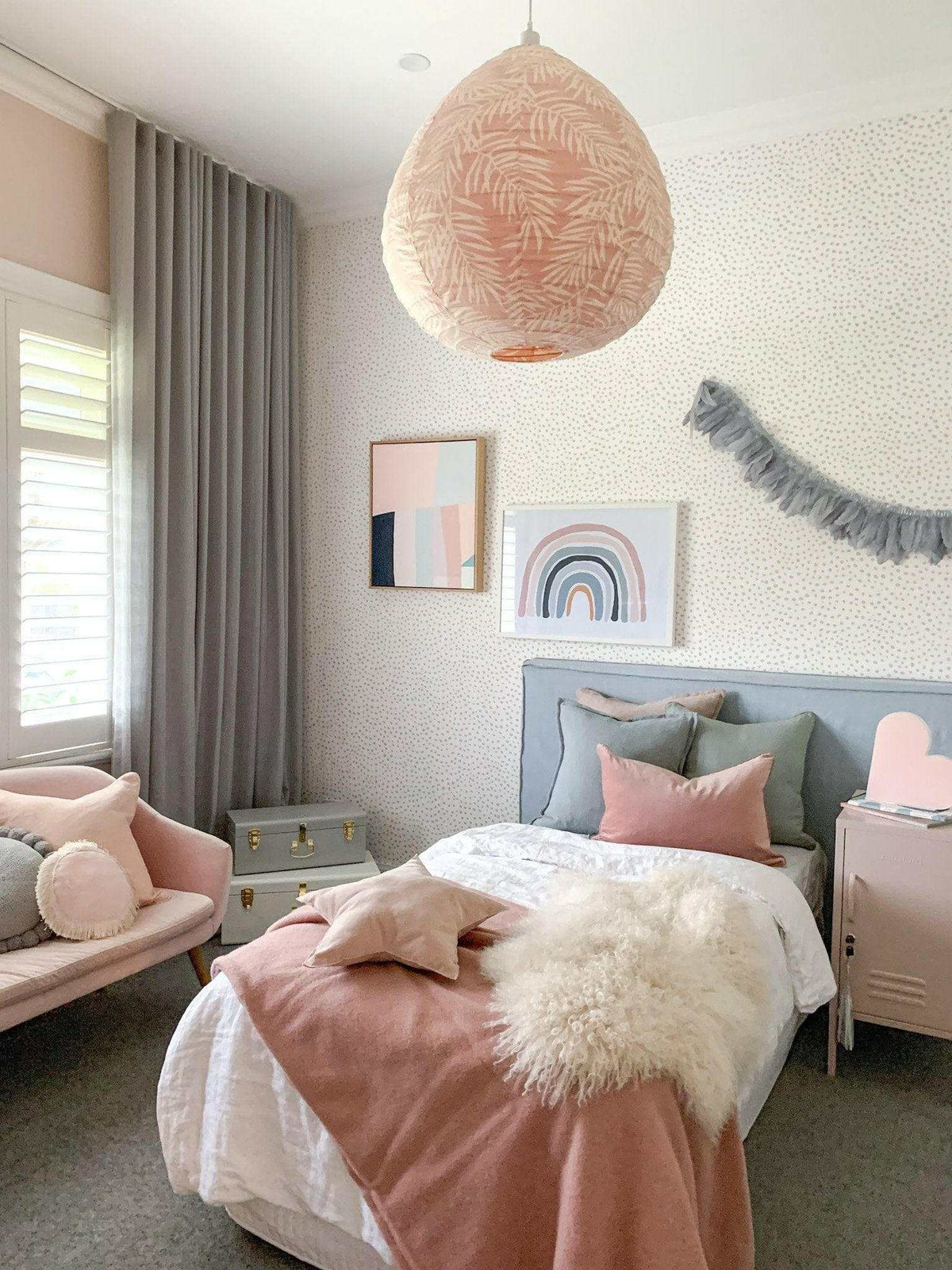 Over The Rainbow blush fine art photographic print in a cozy pastel pink bedroom setting