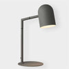 Modern charcoal Pia desk lamp with adjustable arm and cylindrical shade providing focused task lighting