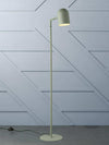 Sleek sage green Pia floor lamp with minimalist architectural design and adjustable head.