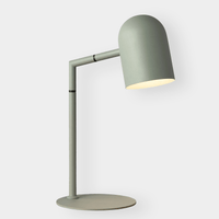 Pia desk lamp in sage green with modern minimalist design and adjustable angled shade for focused lighting
