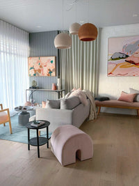 POTT Lighting SpongeUp Pendant lamps in white and terracotta shades hanging in a modern living room with soft decor and artwork