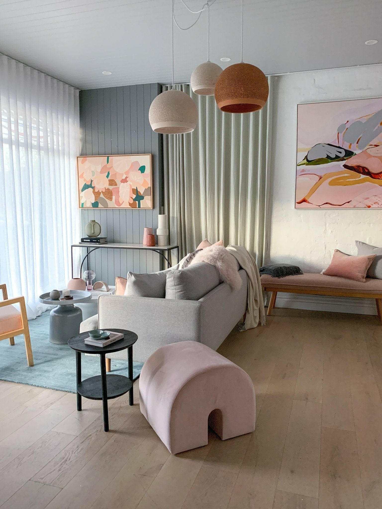 POTT Lighting SpongeUp Pendant lamps in white and terracotta shades hanging in a modern living room with soft decor and artwork