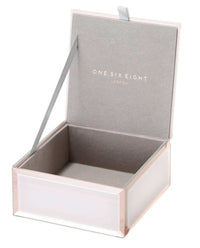 Small blush Sara Jewellery Box with bevelled glass and grey velvet lining, featuring a dainty ribbon tab for lifting the lid.