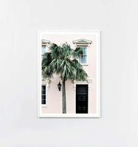 Middle of Nowhere framed print featuring a shaded entrance with palm tree, white frame behind glass, modern wall art.