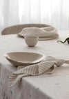 Rendr 100% linen striped olive napkins set of four on table with ceramic bowl and plate