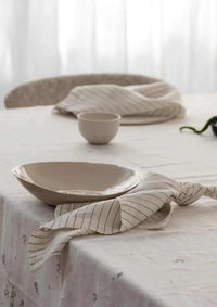 Rendr 100% linen striped olive napkins set of four on table with ceramic bowl and plate