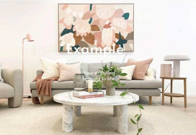 Modern living room with a marble coffee table styled with books, a vase with greenery, and soft neutral-toned sofa cushions for professional coffee table styling eService example.