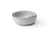 Set of smoke-colored nesting bowls in various sizes from the Nesting Bowls Collection, lightweight and snap-tight design