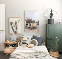 Summer Break Surfboard print on wall above bed in cozy modern bedroom with cactus and soft toys
