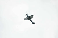 Vintage airplane flying with "THANK NHS" message on wings against clear sky, THANK U Print wall art.