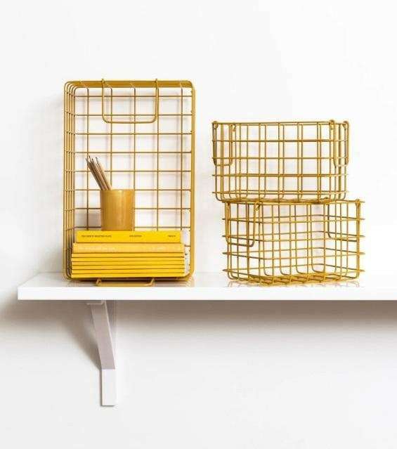 Set of mustard baskets including one large and two small wire storage baskets on a white shelf for organizing bits and bobs