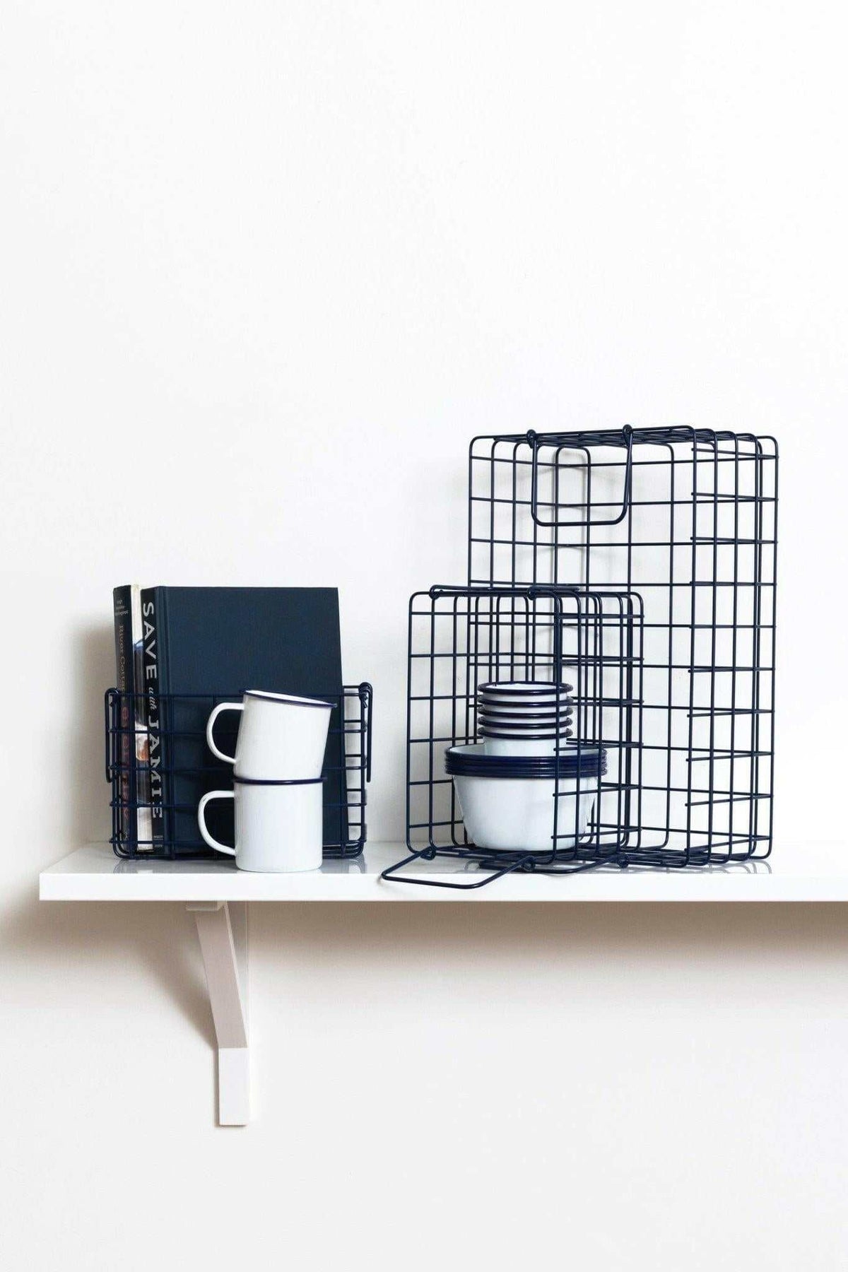 Set of navy wire baskets designed for organizing bits and bobs with different sizes fitting locker shelves.