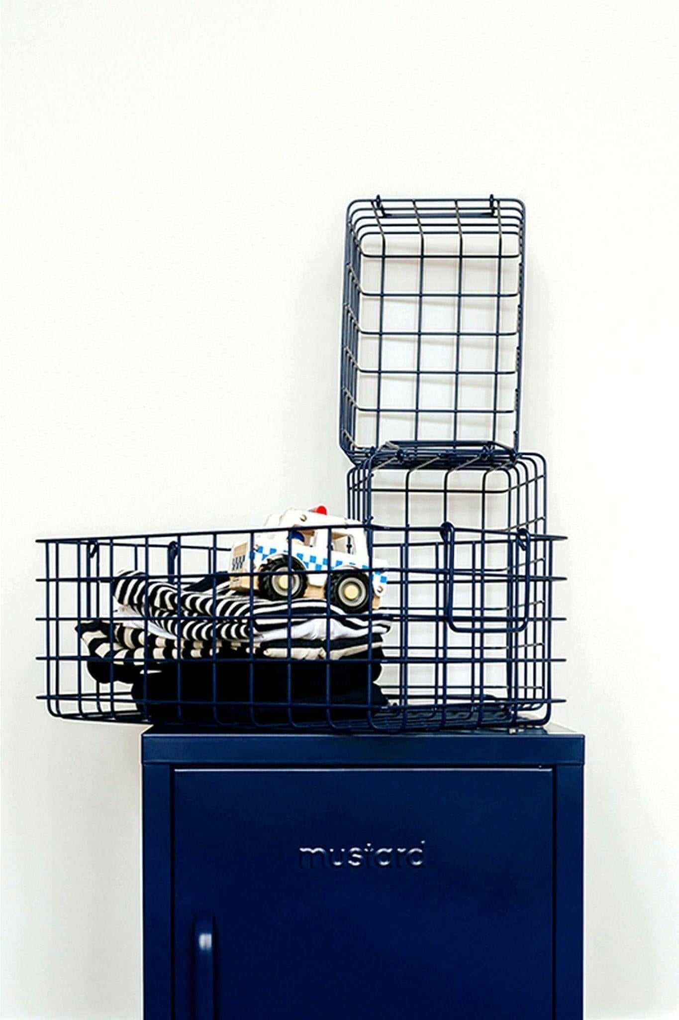 Set of navy wire baskets for all for bits and bobs, designed to fit inside lockers for versatile storage.